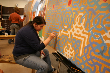 student painting a mural 